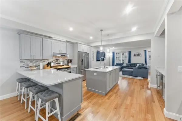 a kitchen with a sink a counter top space and stainless steel appliances