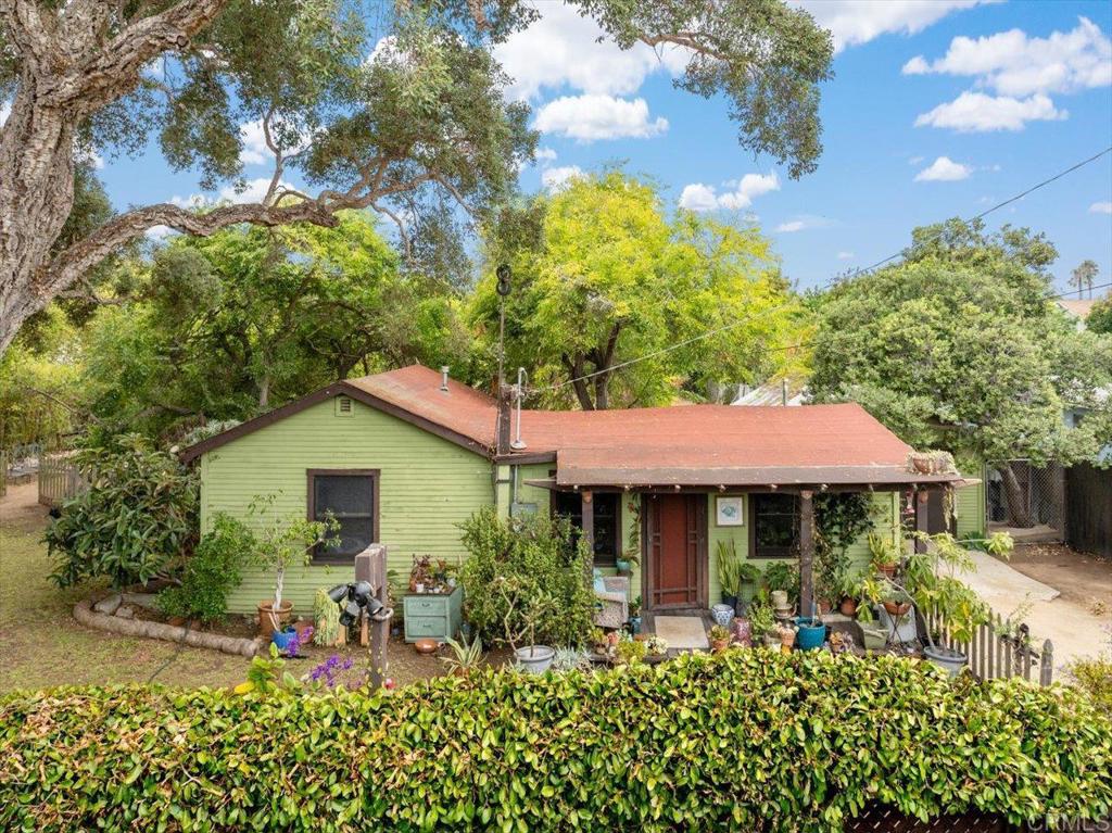 334 Date Avenue Carlsbad, CA 92008 - Photo 1 of 26 a view of a house with table and chairs under an umbrella