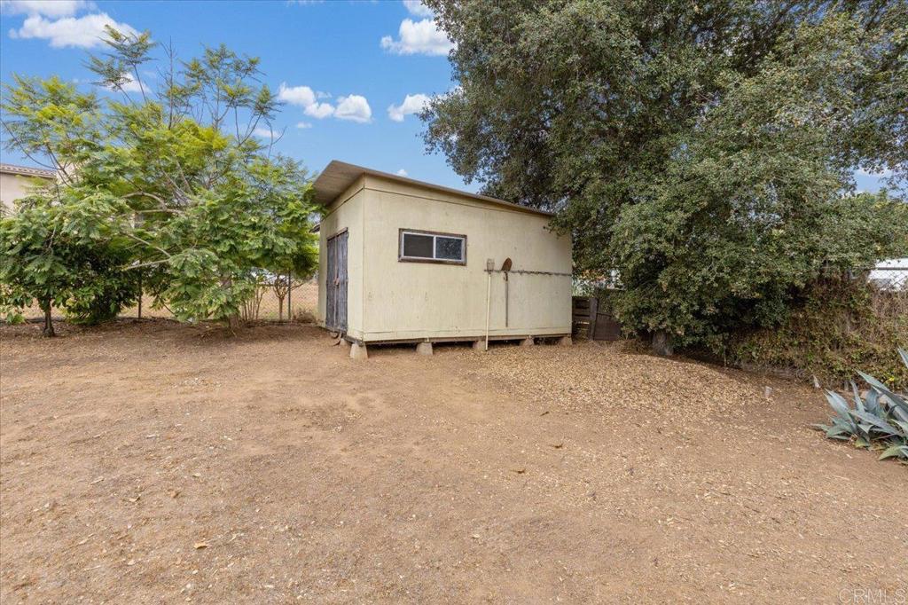 334 Date Avenue Carlsbad, CA 92008 - Photo 12 of 26 a view of backyard with potted plants and large tree