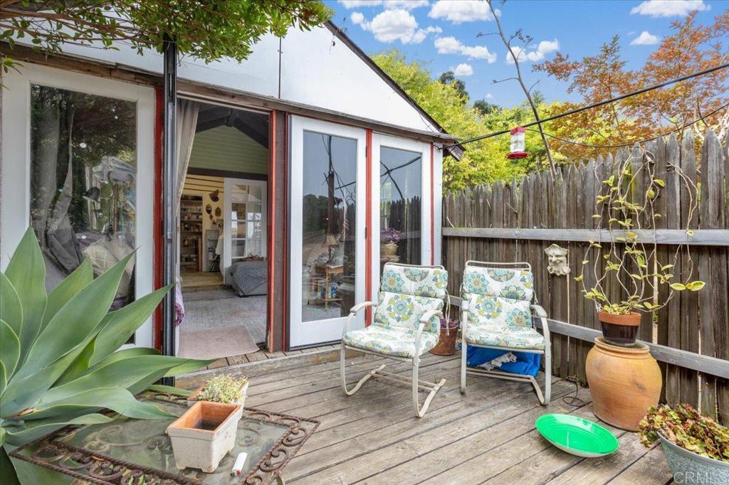 334 Date Avenue Carlsbad, CA 92008 - Photo 15 of 26 a view of a patio with table and chairs potted plants with floor to ceiling window and wooden floor
