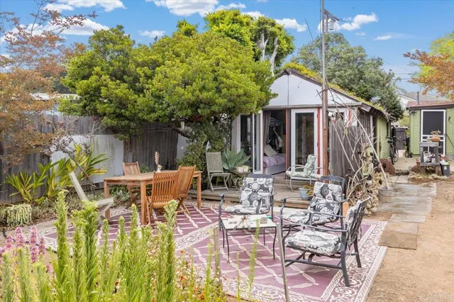 a view of a patio with table and chairs and potted plants