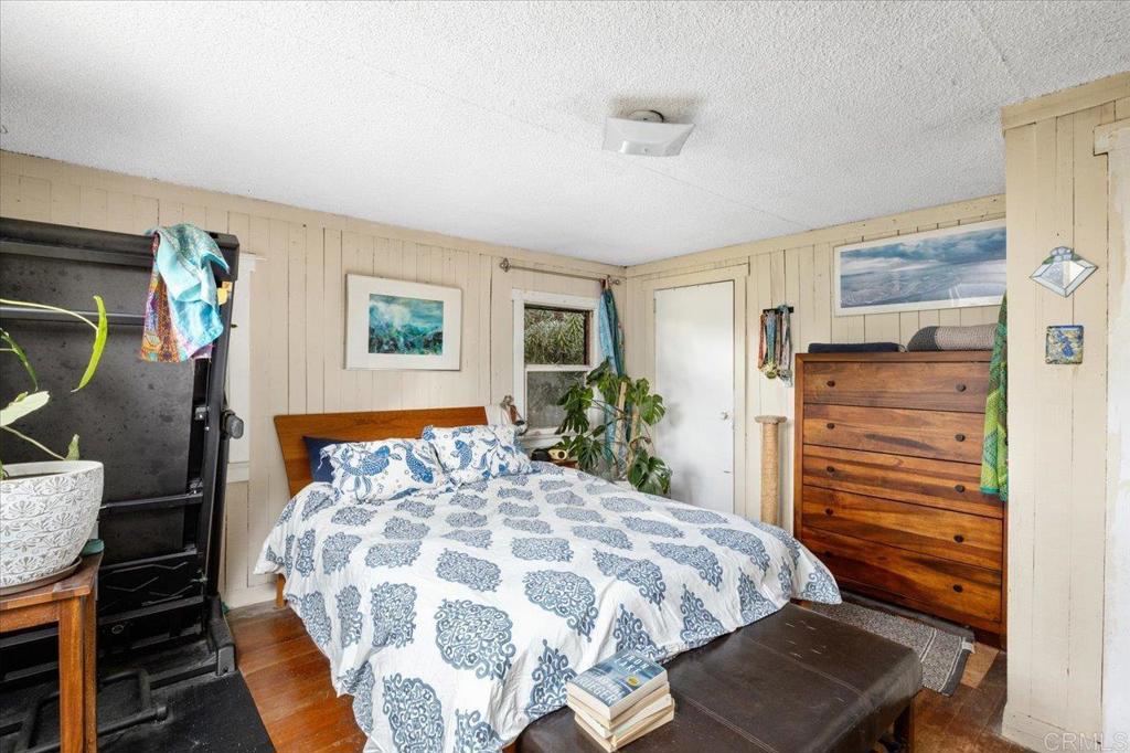 334 Date Avenue Carlsbad, CA 92008 - Photo 23 of 26 a bedroom with a bed and wooden floor