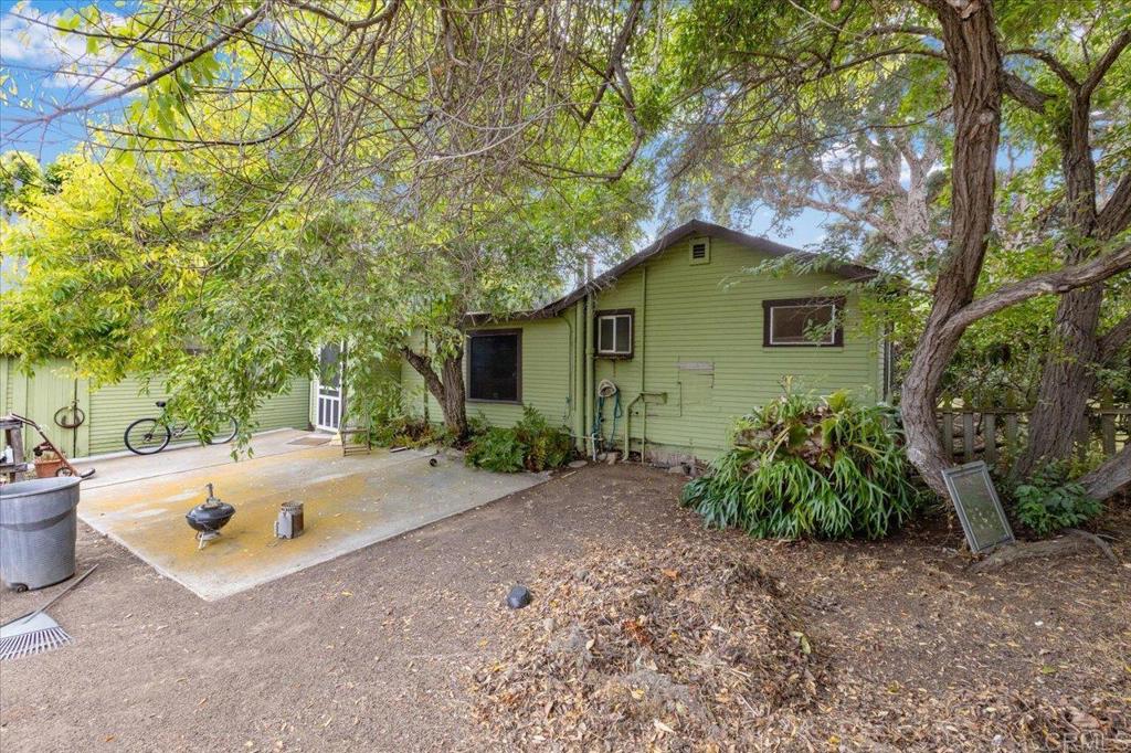 334 Date Avenue Carlsbad, CA 92008 - Photo 6 of 26 a backyard of a house with table and chairs under an umbrella