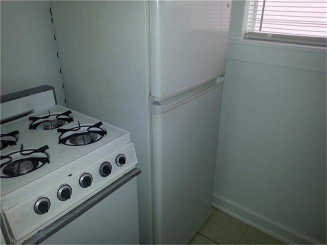 2520 Hopkins Street, Unit I Houston, TX 77006 - Photo 8 of 9 a white stove top oven sitting inside of a kitchen