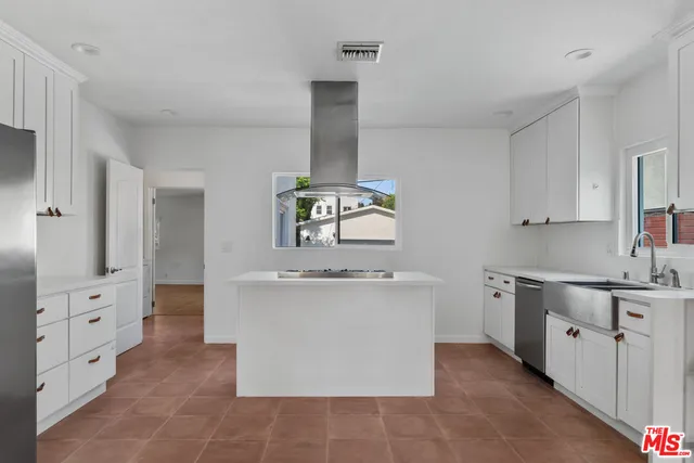 a kitchen with stainless steel appliances and white cabinets