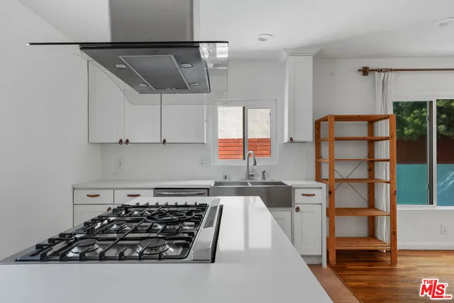 a kitchen with stainless steel appliances granite countertop a stove and a refrigerator