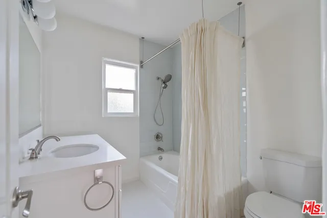 a view of a room with wooden floor and a window