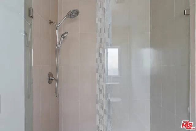 a view of washer and dryer with kitchen in the background