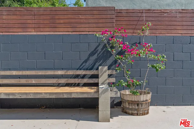 a front view of a house with outdoor seating and plants