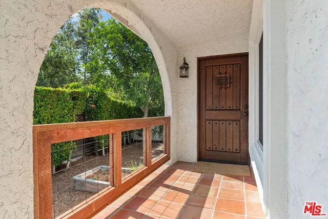 a view of a hallway with wooden floor and a window