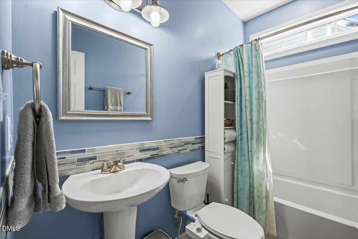 3331 Swinford Court Raleigh, NC 27604 - Photo 22 of 27 a bathroom with a toilet sink and mirror