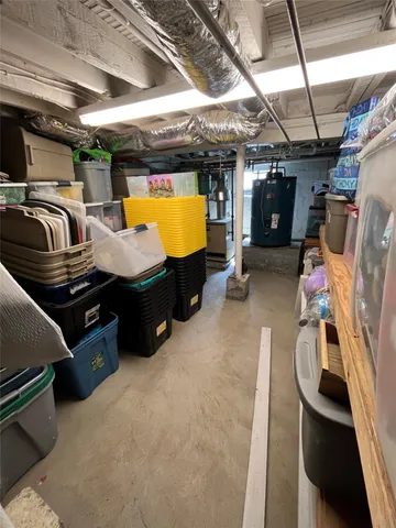a view of a roof deck with table and chairs a barbeque and potted plants