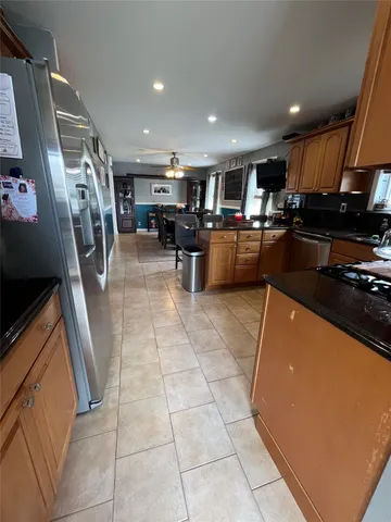 a kitchen with stainless steel appliances granite countertop a sink a stove and a microwave