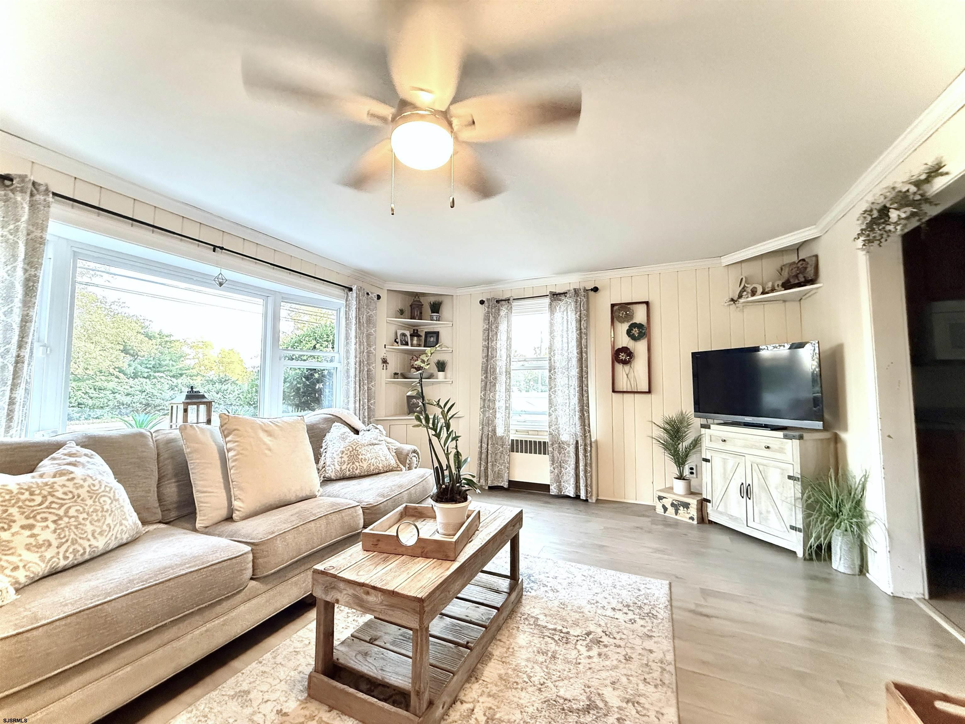 605 Shore Road Linwood, NJ 08221 - Photo 13 of 99 a living room with furniture a flat screen tv and a large window