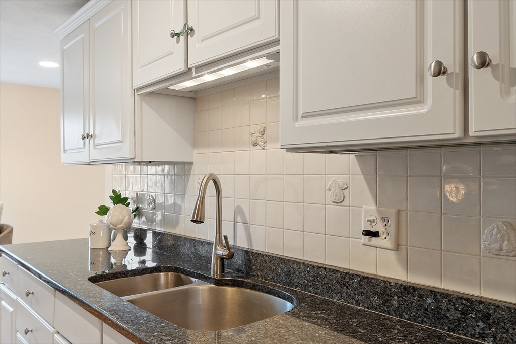 28 Partridge Lane, Unit 28 Lynnfield, MA 01940 - Photo 12 of 41 a kitchen with a sink and cabinets