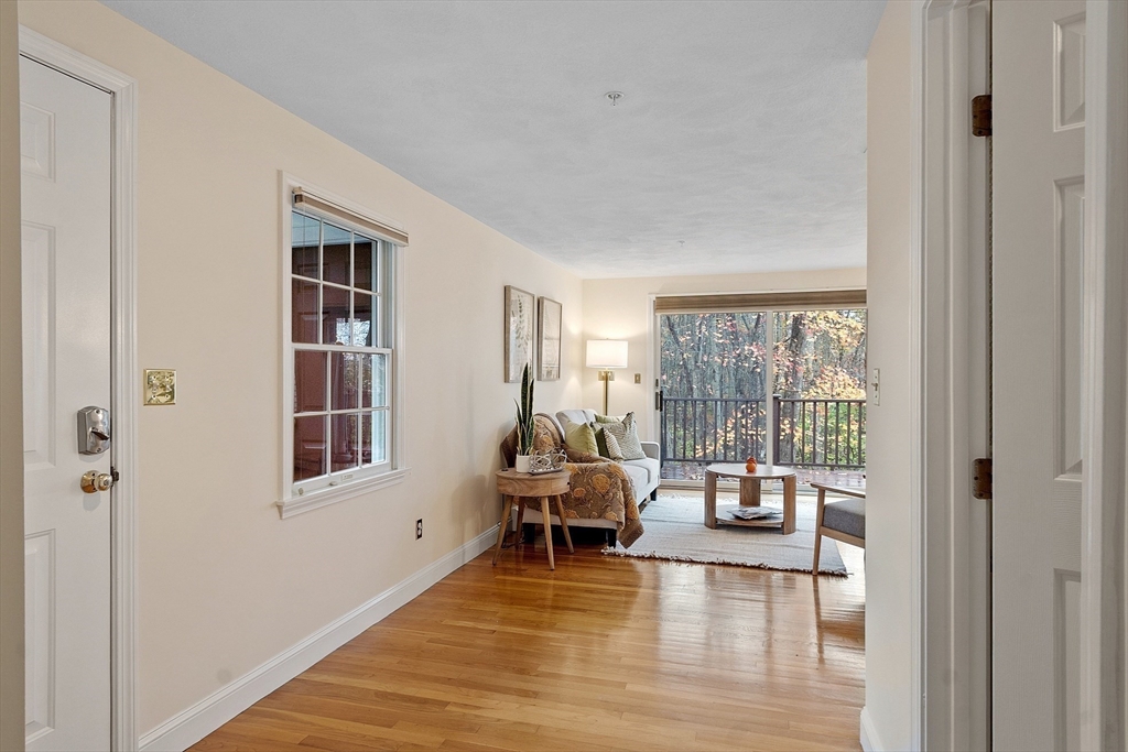 28 Partridge Lane, Unit 28 Lynnfield, MA 01940 - Photo 13 of 41 a living room with furniture floor to ceiling window and wooden floor