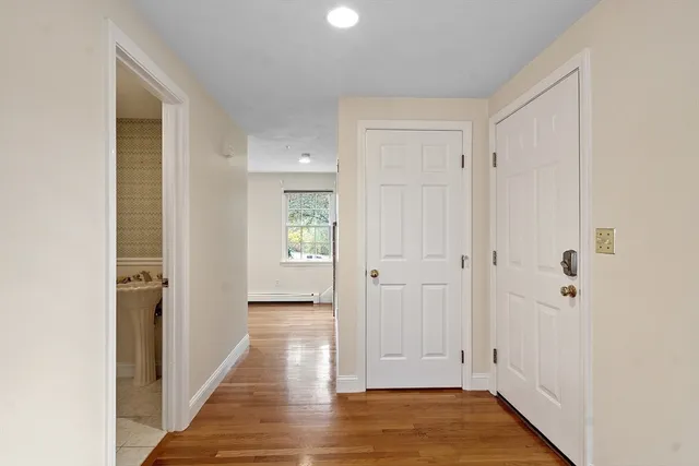a view of a hallway with wooden floor
