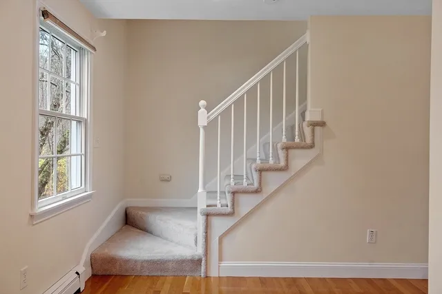 a view of entryway and hall with wooden floor