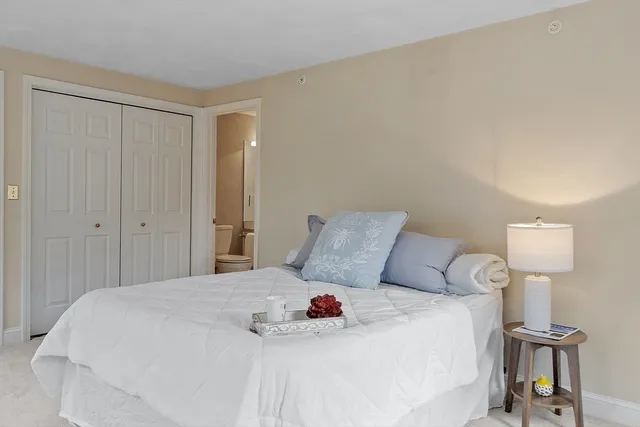 a bedroom with a bed and a table