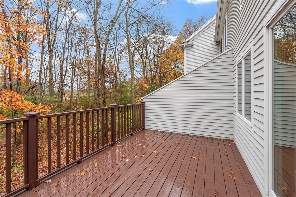 28 Partridge Lane, Unit 28 Lynnfield, MA 01940 - Photo 35 of 41 a view of a wooden balcony with wooden floor and fence