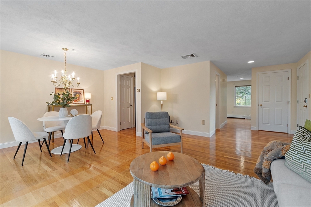 28 Partridge Lane, Unit 28 Lynnfield, MA 01940 - Photo 7 of 41 a view of a dining room with furniture and wooden floor