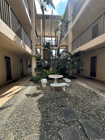a backyard of a house with yard and outdoor seating