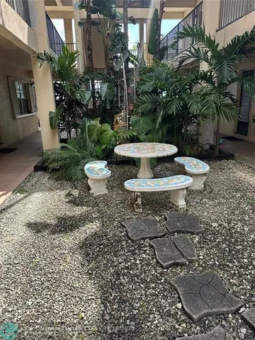a backyard of a house with yard and outdoor seating