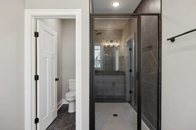 a bathroom with a glass shower door
