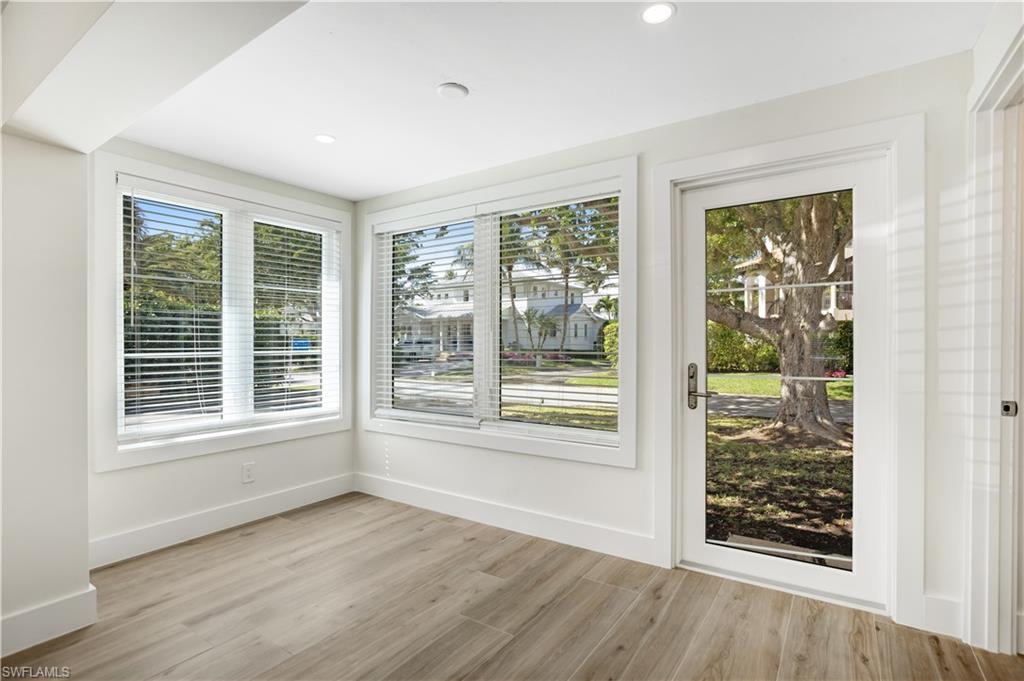 1019 7th Street South Naples, FL 34102 - Photo 2 of 30 a view of an empty room with wooden floor and a window