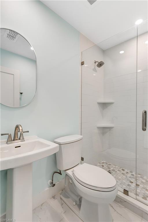 1019 7th Street South Naples, FL 34102 - Photo 21 of 30 a bathroom with a sink a toilet and shower