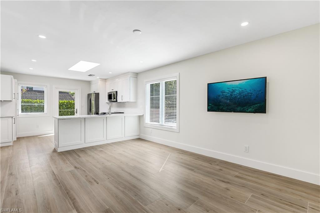 1019 7th Street South Naples, FL 34102 - Photo 4 of 30 a view of empty room with wooden floor and windows