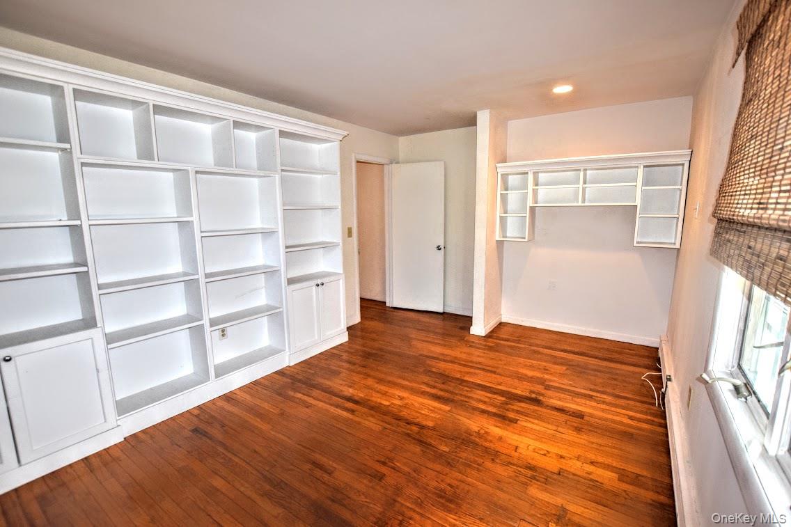 41 Country Club Road Bellport, NY 11713 - Photo 15 of 18 Unfurnished bedroom featuring dark wood-type flooring, recessed lighting, and a closet
