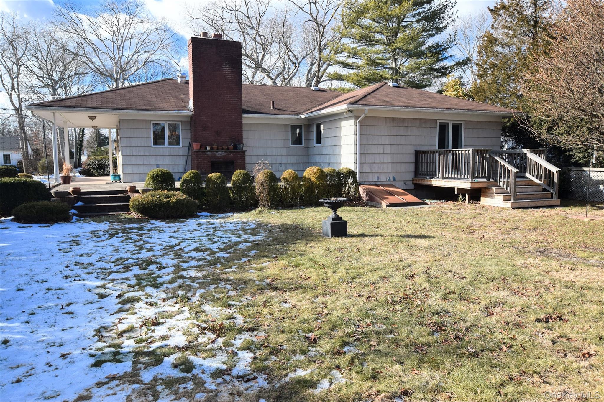 41 Country Club Road Bellport, NY 11713 - Photo 6 of 18 Back of property with a deck, a lawn, and a chimney