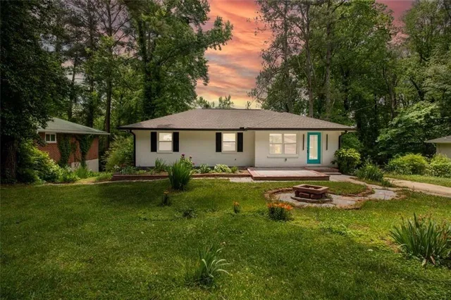 a front view of a house with a yard patio and swimming pool