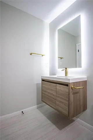 a bathroom with a sink and vanity