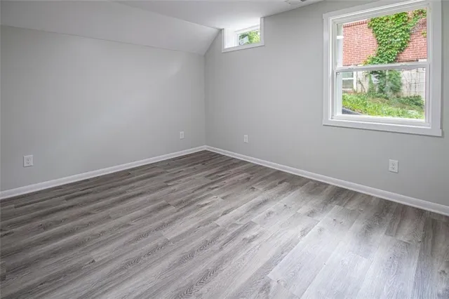 a view of room with window and wooden floor