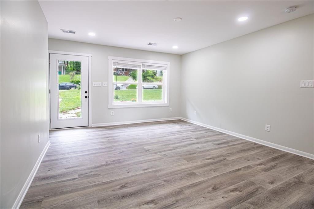 3699 Larkspur Terrace Decatur, GA 30032 - Photo 18 of 29 an empty room with wooden floor and windows