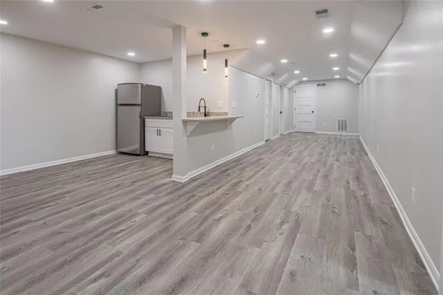 a view of kitchen cabinet and refrigerator