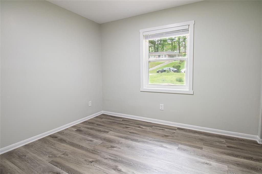 3699 Larkspur Terrace Decatur, GA 30032 - Photo 25 of 29 wooden floor in an empty room with a window