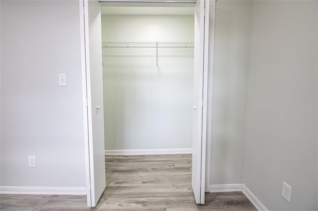 3699 Larkspur Terrace Decatur, GA 30032 - Photo 26 of 29 a view of an empty walk in closet with wooden floor