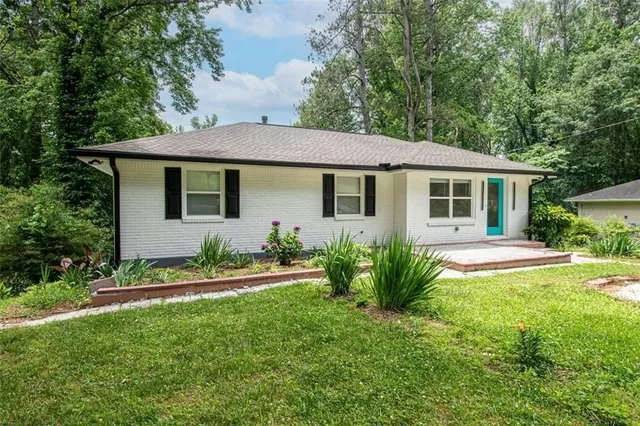 a house that has a lot of plants and trees in it