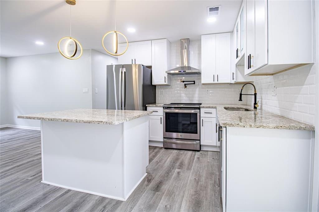 3699 Larkspur Terrace Decatur, GA 30032 - Photo 5 of 29 a kitchen with stainless steel appliances granite countertop a sink stove and refrigerator