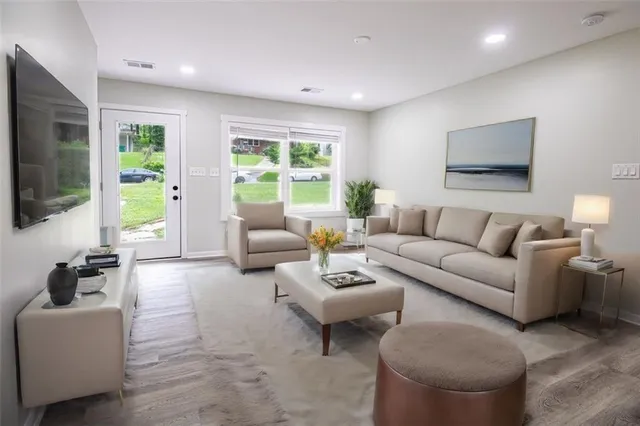 a living room with furniture and a flat screen tv
