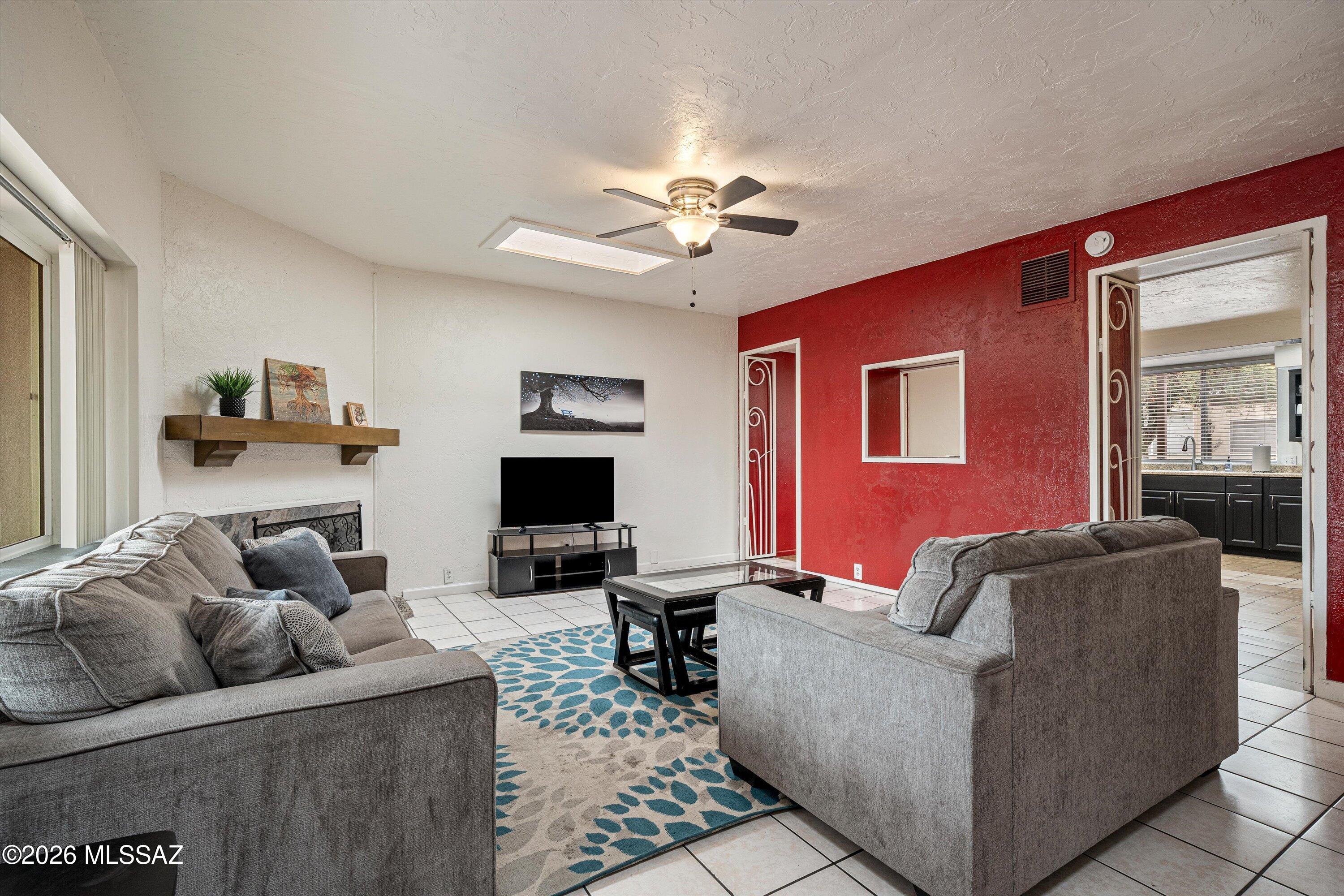2619 East Prince Road Tucson, AZ 85716 - Photo 14 of 50 a living room with furniture and a flat screen tv with kitchen view
