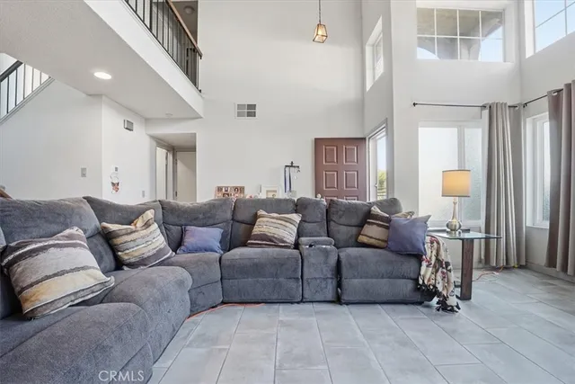 a living room with furniture a wooden floor and a chandelier