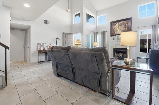 a living room with furniture a fireplace and a table