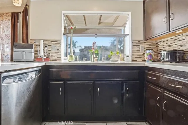 a kitchen with a sink a counter top space and a large window