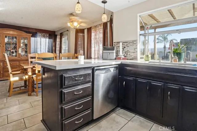 a kitchen with a sink a stove cabinets and a glass door