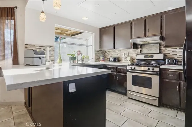 a kitchen with stainless steel appliances a stove sink and cabinets