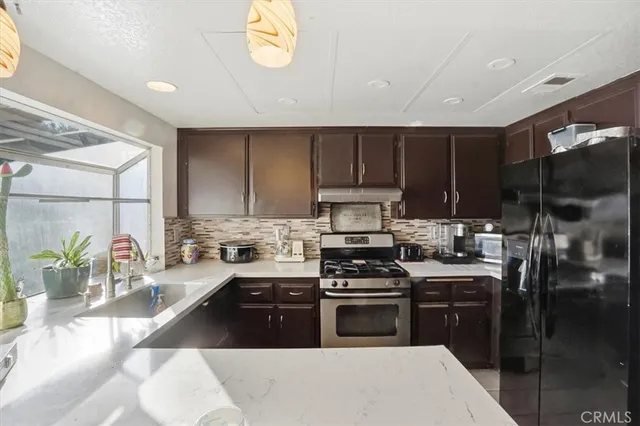 a kitchen with a stove a sink and a microwave